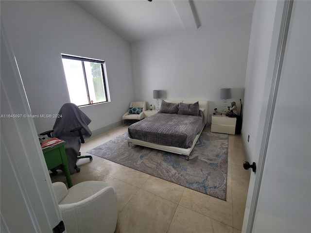 bedroom featuring light tile patterned floors and vaulted ceiling