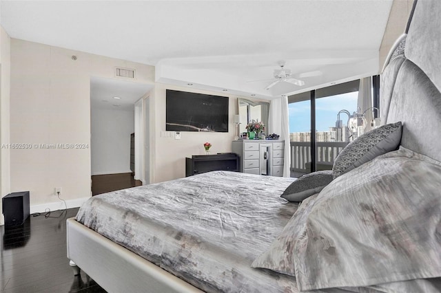 bedroom with wood-type flooring, expansive windows, access to exterior, and ceiling fan