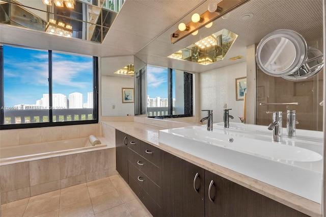 bathroom with vanity, tiled bath, and tile patterned floors