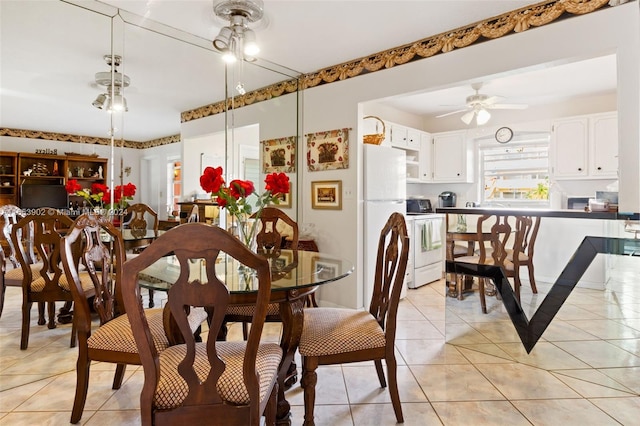 tiled dining room featuring ceiling fan