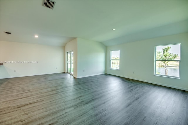 spare room with vaulted ceiling and hardwood / wood-style floors