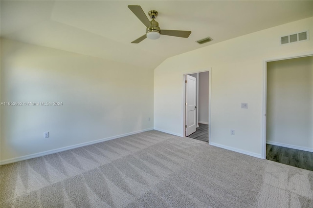 carpeted empty room with lofted ceiling and ceiling fan