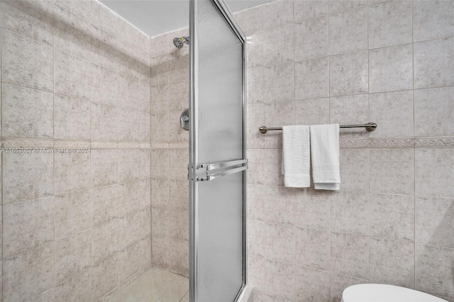 bathroom with walk in shower and toilet