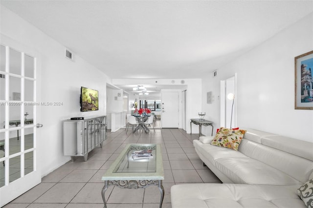 tiled living room featuring ceiling fan