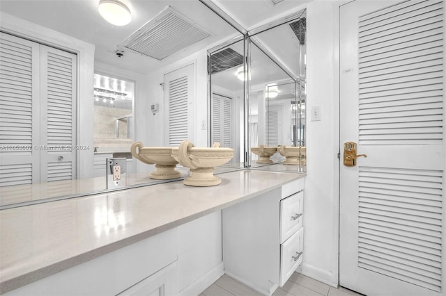 bathroom featuring tile patterned flooring and vanity