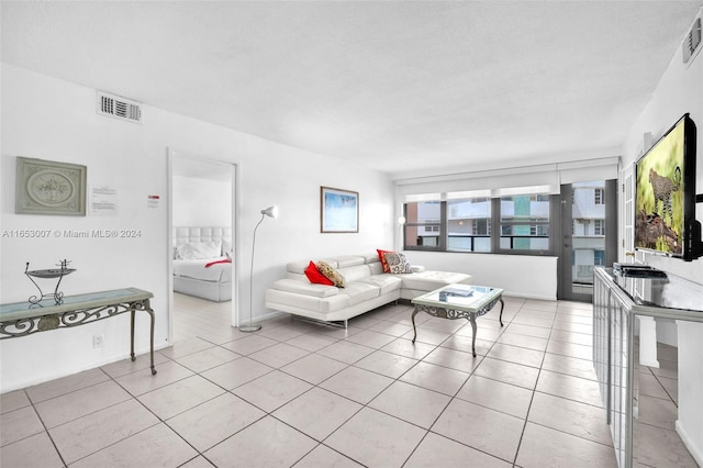 tiled living room with a textured ceiling