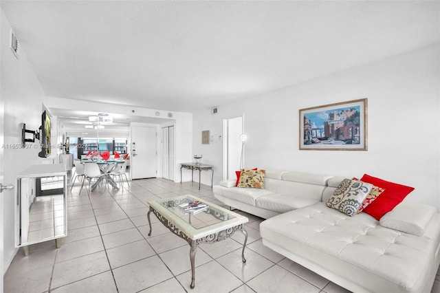 living room featuring a textured ceiling and light tile patterned flooring