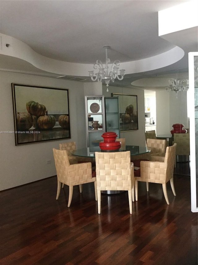 dining room featuring dark wood-type flooring and a notable chandelier