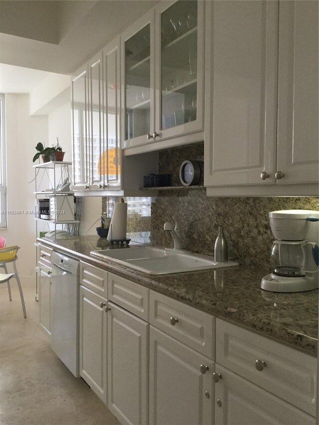 kitchen featuring white cabinetry, white dishwasher, sink, and decorative backsplash