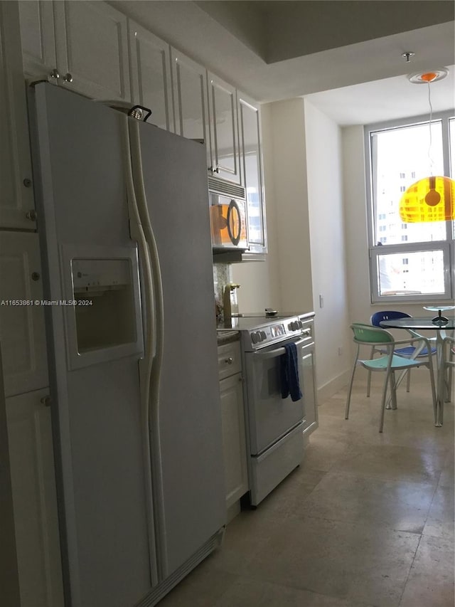 808 Brickell Key Dr Unit 2005, Miami, FL 33131 - kitchen with white appliances, healthy amount of natural light, and white cabinetry
