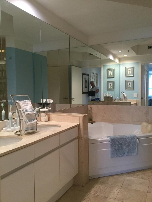 bathroom featuring vanity and a washtub