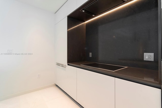 kitchen with white cabinetry and black electric cooktop