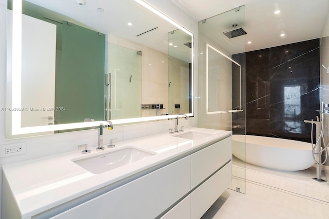 bathroom featuring plus walk in shower, tile patterned flooring, and vanity