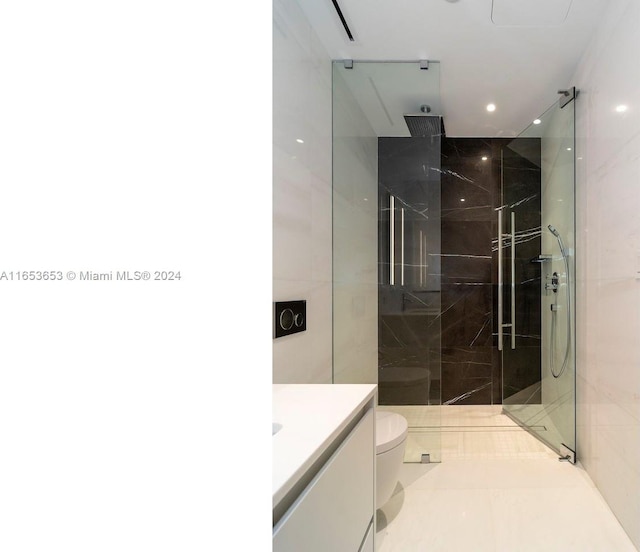 bathroom featuring walk in shower, vanity, toilet, and tile patterned floors