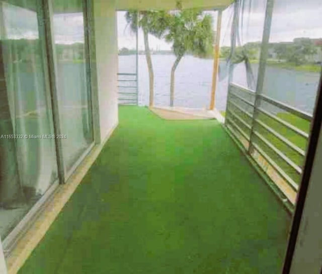 unfurnished sunroom featuring a water view