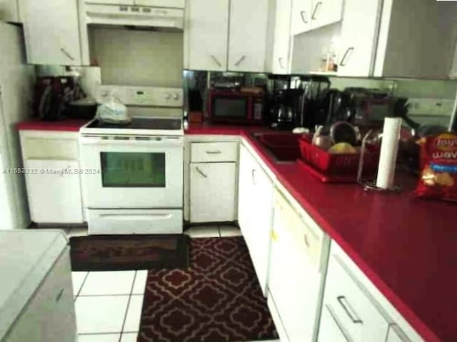 kitchen featuring white cabinets, white appliances, and light tile patterned flooring