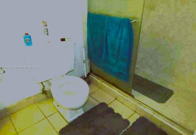 bathroom with toilet and tile patterned floors