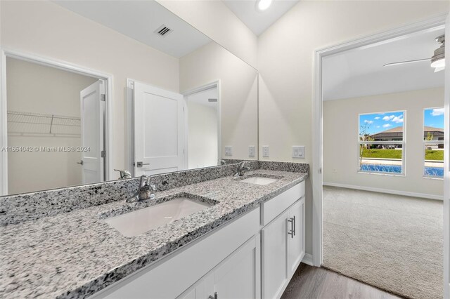 bathroom with vanity, lofted ceiling, hardwood / wood-style floors, and ceiling fan