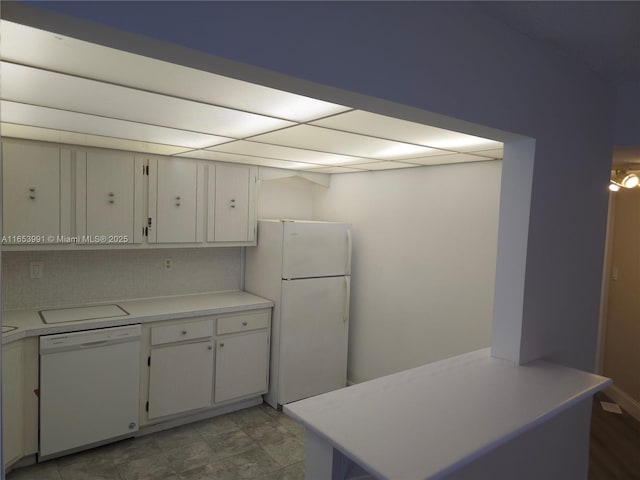 kitchen with white cabinetry, tasteful backsplash, white appliances, and light countertops