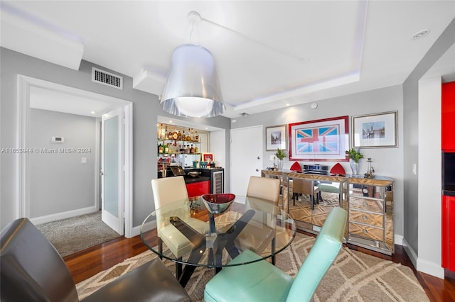 dining room featuring bar and dark hardwood / wood-style flooring