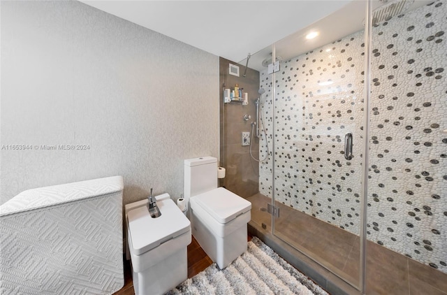 bathroom featuring hardwood / wood-style floors, toilet, and an enclosed shower