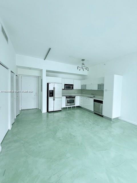 unfurnished living room featuring sink