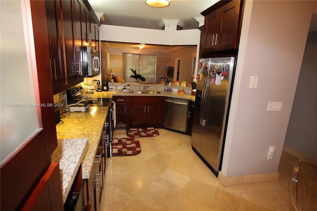 kitchen featuring a textured ceiling, appliances with stainless steel finishes, crown molding, sink, and light stone counters