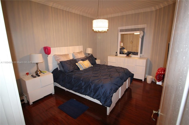 bedroom featuring crown molding and dark hardwood / wood-style flooring