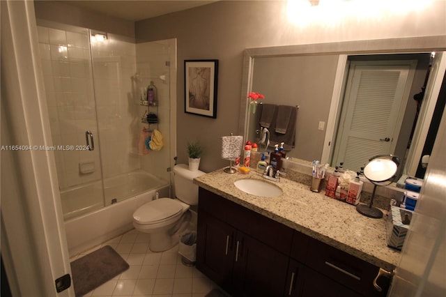 full bathroom with vanity, toilet, tile patterned floors, and bath / shower combo with glass door