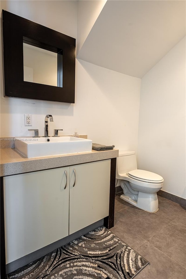 bathroom featuring tile patterned flooring, vanity, and toilet