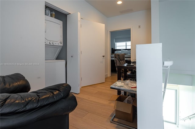 living room featuring light hardwood / wood-style flooring and stacked washer / drying machine