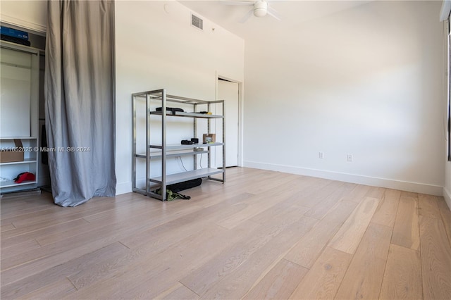 interior space with light wood-type flooring, a closet, and ceiling fan