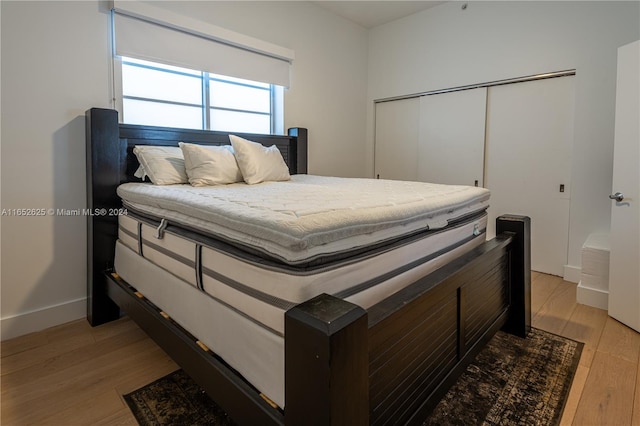 bedroom featuring a closet and light wood-type flooring