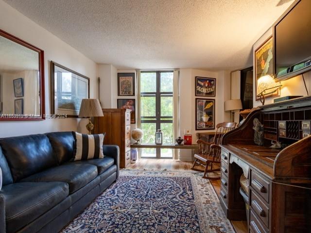 living room with hardwood / wood-style flooring and a textured ceiling