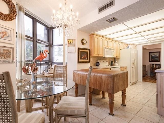 dining room featuring an inviting chandelier and light tile patterned floors