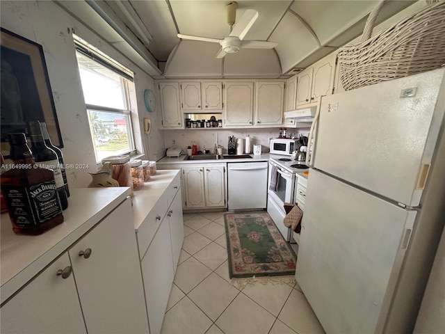 kitchen with white appliances, white cabinetry, lofted ceiling, ceiling fan, and light tile patterned flooring