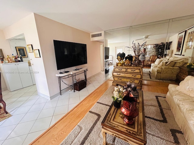 living room featuring light hardwood / wood-style flooring and ceiling fan