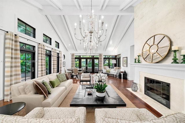 living room with high vaulted ceiling, a high end fireplace, hardwood / wood-style floors, beamed ceiling, and a notable chandelier