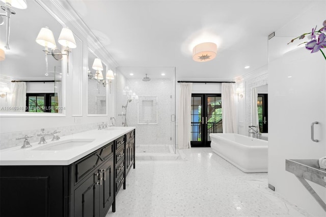 bathroom featuring vanity, french doors, ornamental molding, and shower with separate bathtub