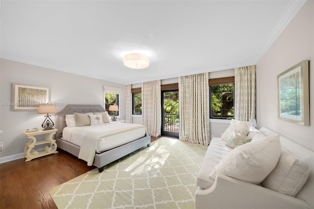 bedroom with a notable chandelier, access to outside, crown molding, dark wood-type flooring, and french doors