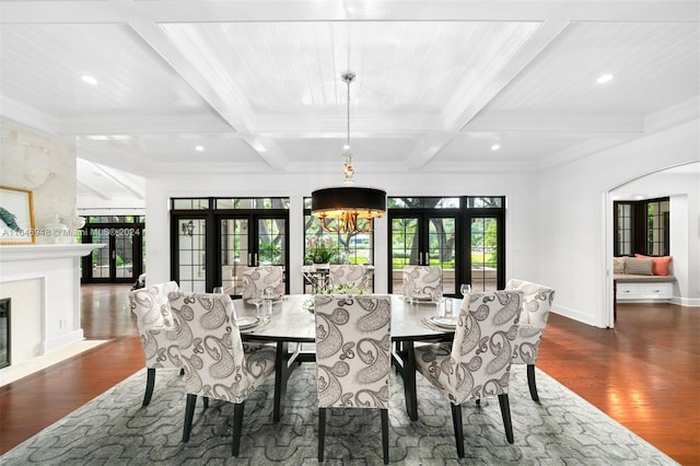 dining room featuring french doors, a healthy amount of sunlight, dark wood-type flooring, and beamed ceiling