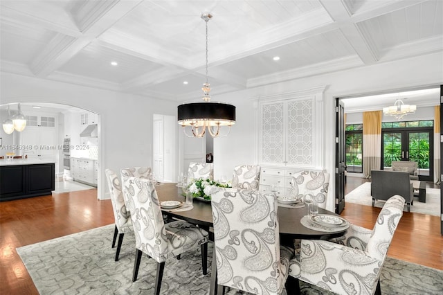 dining room with coffered ceiling, french doors, beam ceiling, ornamental molding, and light hardwood / wood-style floors