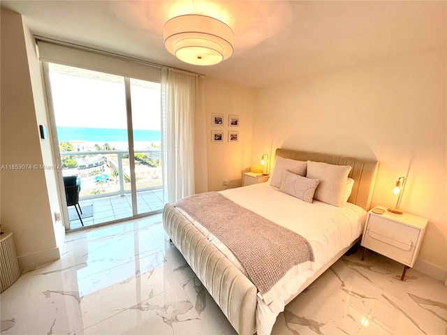 bedroom featuring a water view and access to outside