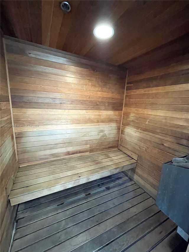 view of sauna featuring wooden ceiling, wood-type flooring, and wood walls