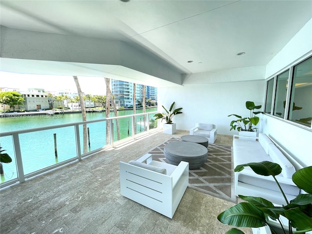 balcony with a fire pit and a water view