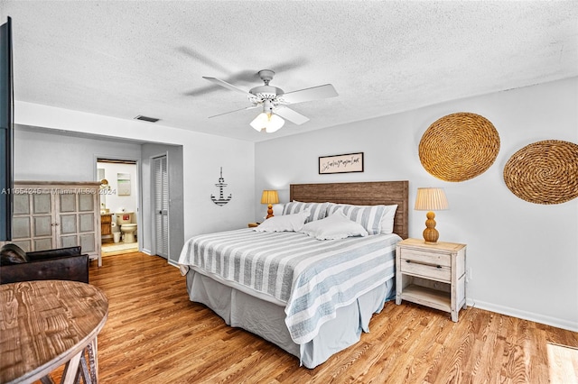 bedroom featuring a textured ceiling, light hardwood / wood-style flooring, and ceiling fan