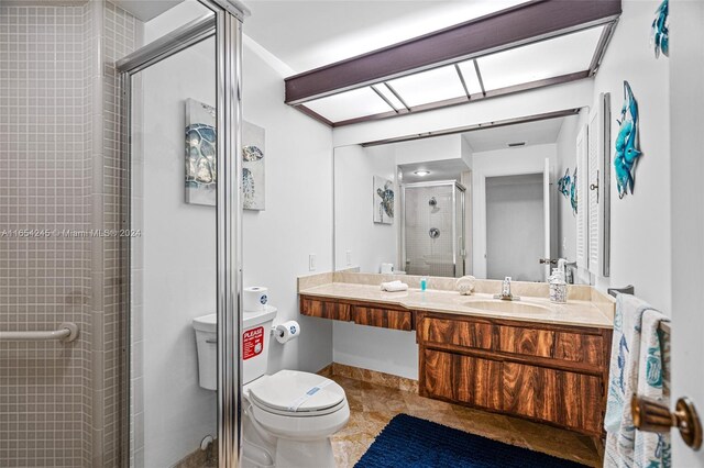 bathroom with vanity, toilet, and an enclosed shower