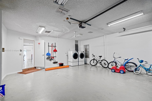 garage featuring a garage door opener, washer and dryer, and ceiling fan