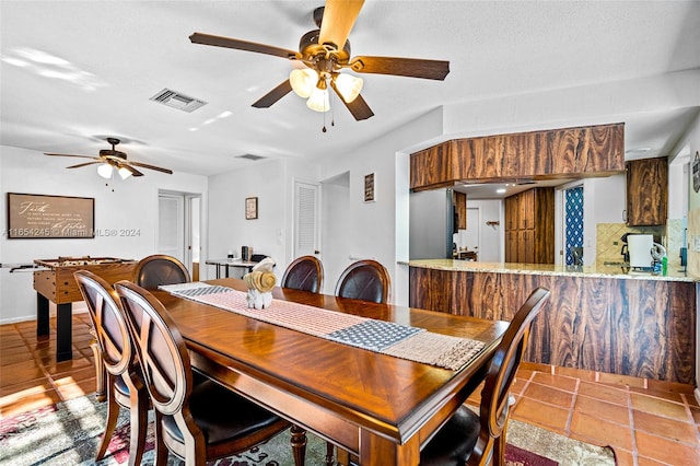 dining space with a textured ceiling and ceiling fan