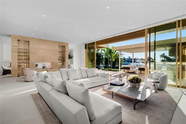 living room with floor to ceiling windows and wooden walls